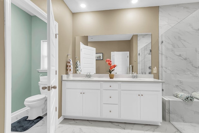 bathroom with an enclosed shower, vanity, and toilet