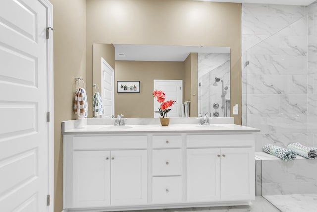 bathroom with vanity and a tile shower