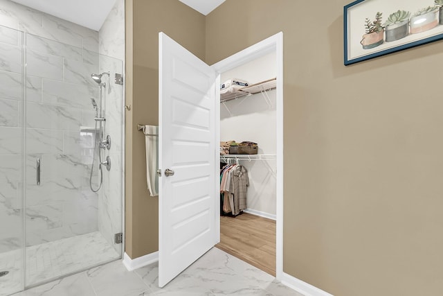 bathroom with an enclosed shower and hardwood / wood-style floors