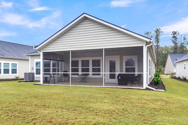 rear view of house featuring a patio, a sunroom, and a lawn