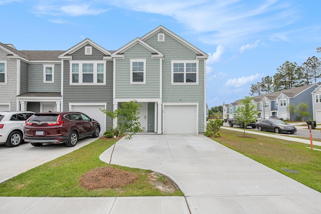 multi unit property with concrete driveway, a garage, a residential view, and a front yard