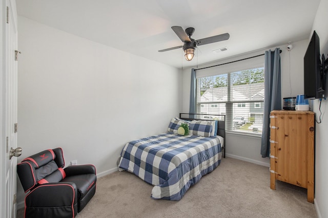 bedroom with baseboards, light colored carpet, and ceiling fan