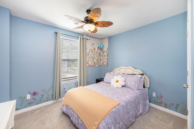 carpeted bedroom featuring baseboards and ceiling fan