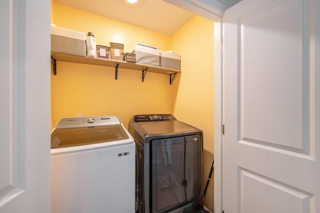 clothes washing area featuring washer and dryer