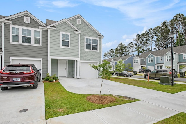 view of front of house with concrete driveway, an attached garage, a residential view, and a front lawn