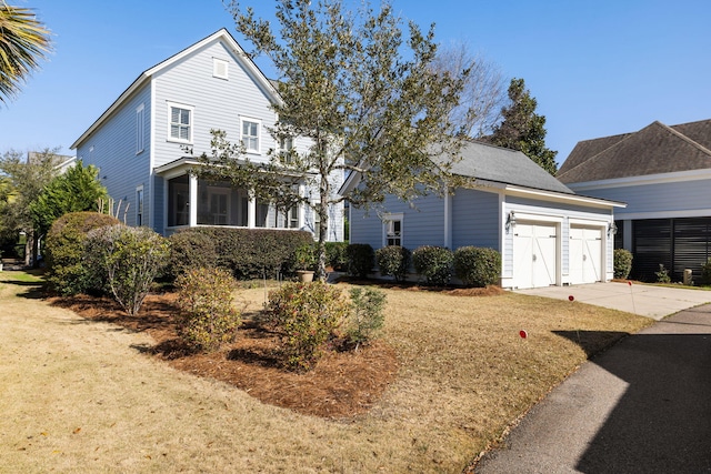 front of property featuring a sunroom and a front lawn