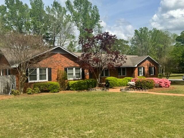1153 Cherokee Dr, Manning, SC 29102 - ranch-style home with a front yard and brick siding