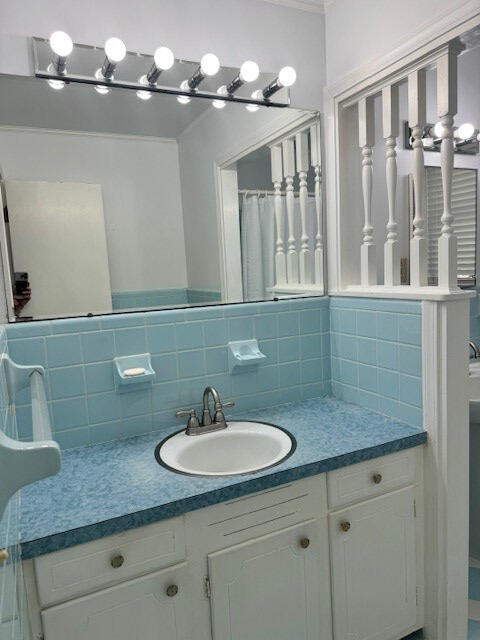 1153 Cherokee Dr, Manning, SC 29102 - bathroom featuring vanity, tasteful backsplash, and crown molding