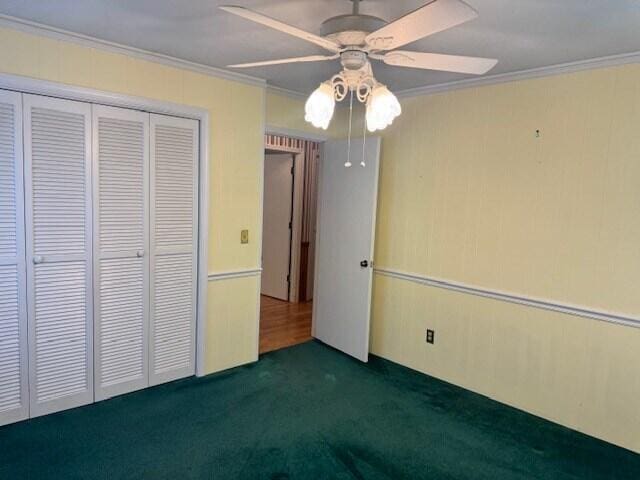 1153 Cherokee Dr, Manning, SC 29102 - unfurnished bedroom with crown molding, dark carpet, a closet, and ceiling fan