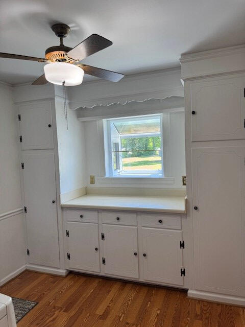 1153 Cherokee Dr, Manning, SC 29102 - kitchen with wood finished floors, white cabinetry, light countertops, and ceiling fan