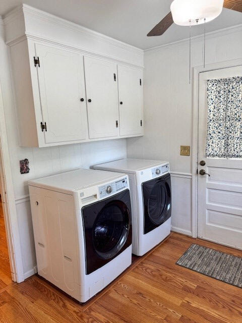 1153 Cherokee Dr, Manning, SC 29102 - laundry room featuring cabinet space, washing machine and clothes dryer, light wood-style floors, a ceiling fan, and ornamental molding