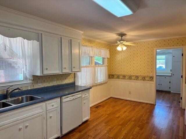 1153 Cherokee Dr, Manning, SC 29102 - kitchen featuring dishwasher, a sink, dark countertops, dark wood finished floors, and crown molding