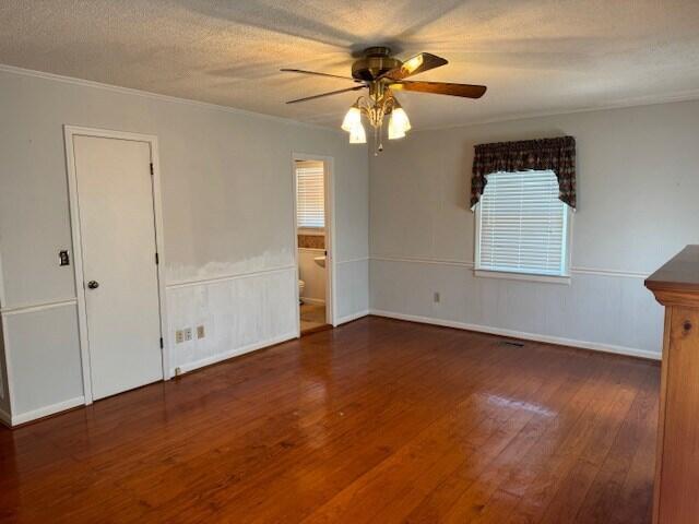 1153 Cherokee Dr, Manning, SC 29102 - spare room featuring wood-type flooring, a ceiling fan, crown molding, baseboards, and a textured ceiling