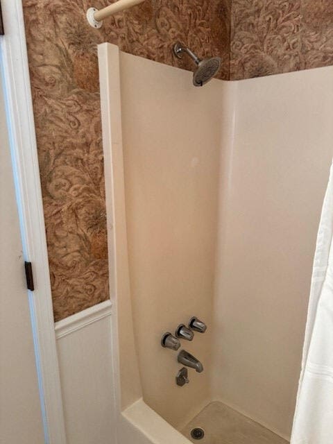 1153 Cherokee Dr, Manning, SC 29102 - bathroom featuring wallpapered walls, wainscoting, and shower / bath combination with curtain