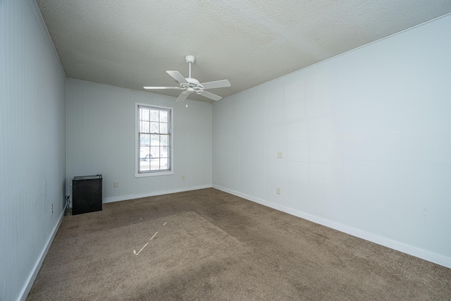 carpeted empty room featuring ceiling fan and a textured ceiling