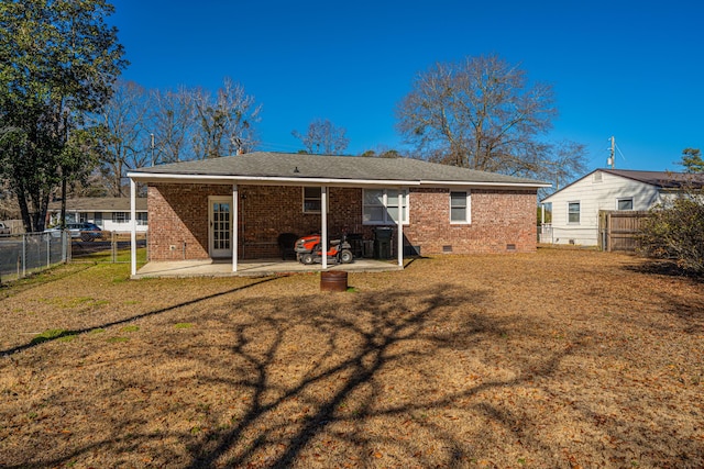 back of house with a patio area and a lawn