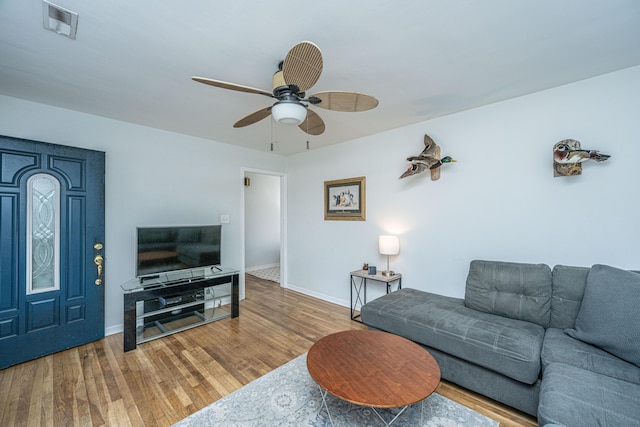 living room with hardwood / wood-style floors and ceiling fan