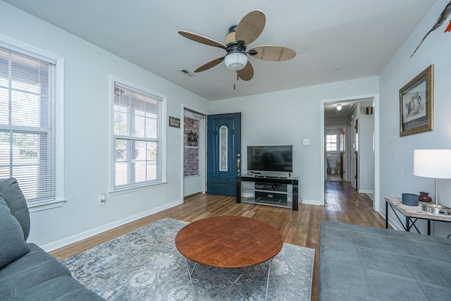 living room with hardwood / wood-style floors, plenty of natural light, and ceiling fan