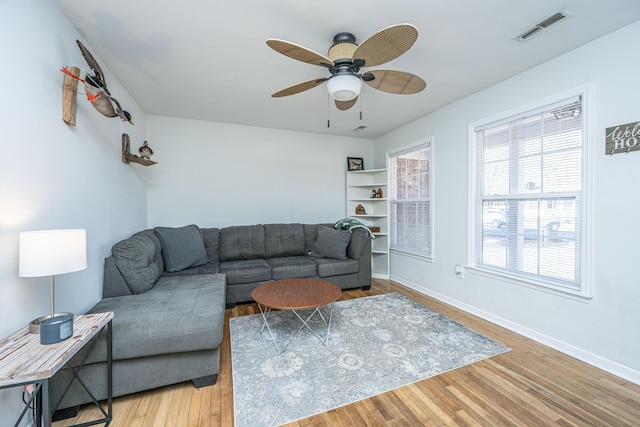 living room featuring hardwood / wood-style flooring and ceiling fan