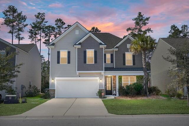 view of front of property with a yard and a garage