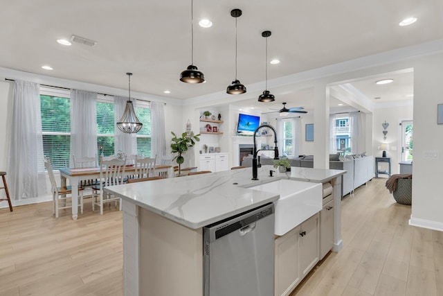 1576 Nautical Chart Dr, Charleston, SC 29414 - kitchen with stainless steel dishwasher, a sink, open floor plan, light wood-style floors, and plenty of natural light