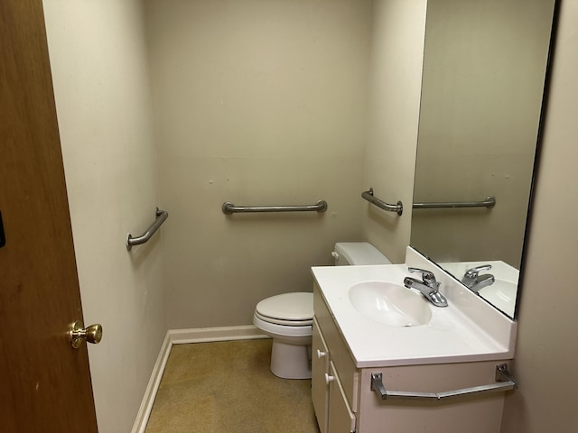 bathroom with toilet, baseboards, and vanity