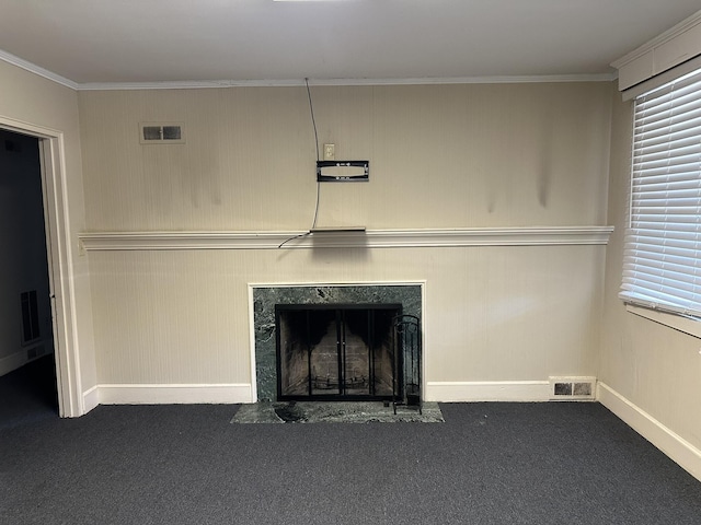 room details with visible vents, a fireplace, crown molding, carpet floors, and baseboards