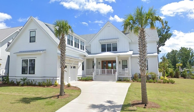 3807 Sawyers Island Dr, Mount Pleasant, SC 29466 - modern farmhouse featuring a porch, a garage, board and batten siding, concrete driveway, and a front lawn