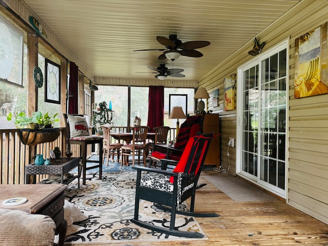 sunroom / solarium featuring ceiling fan