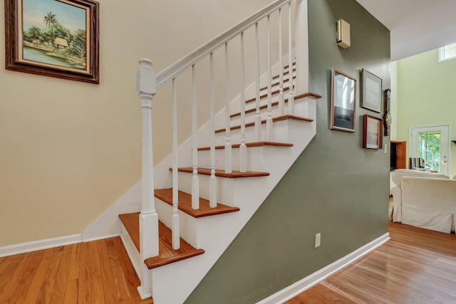 stairs featuring wood-type flooring