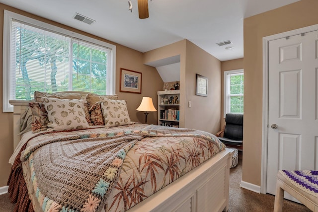 carpeted bedroom featuring multiple windows and ceiling fan