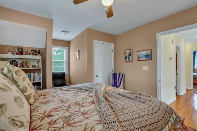 bedroom with a closet, ceiling fan, and light hardwood / wood-style flooring