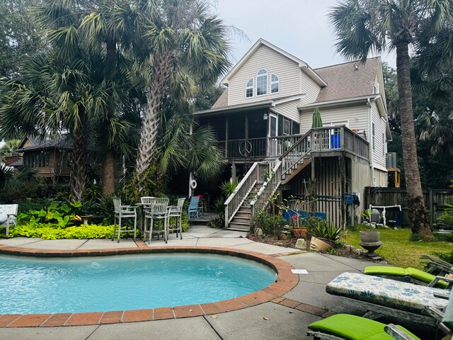 view of pool featuring a patio and a sunroom