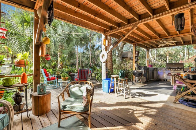 deck with ceiling fan, exterior kitchen, and grilling area