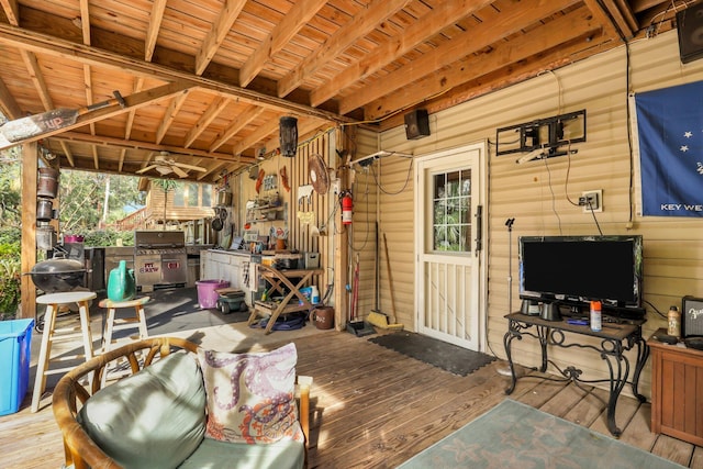 view of patio featuring area for grilling, ceiling fan, and a wooden deck