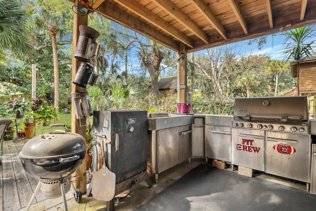 view of patio with area for grilling and a grill