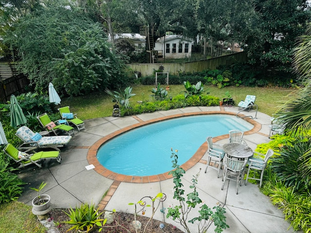 view of pool featuring a yard and a patio area