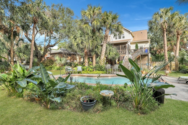 view of pool featuring a deck, a patio area, and a lawn