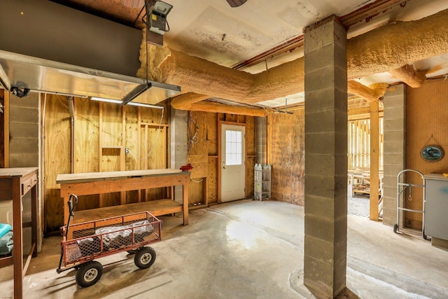 miscellaneous room featuring a workshop area and concrete floors