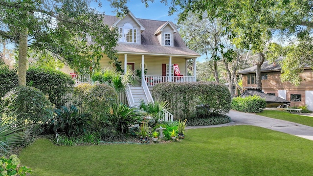 cape cod house with a porch and a front lawn