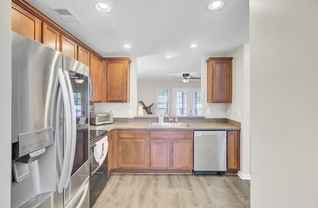 1005 Washitonia Way Unit B, Charleston, SC 29492 - kitchen with dishwashing machine, stainless steel fridge with ice dispenser, black electric range oven, a sink, and brown cabinetry