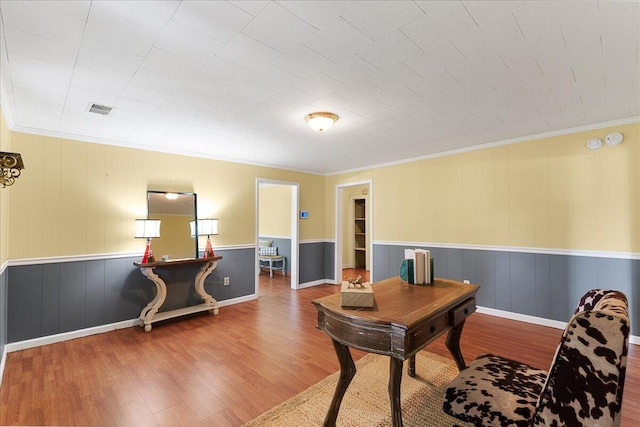 office area featuring wood-type flooring and crown molding