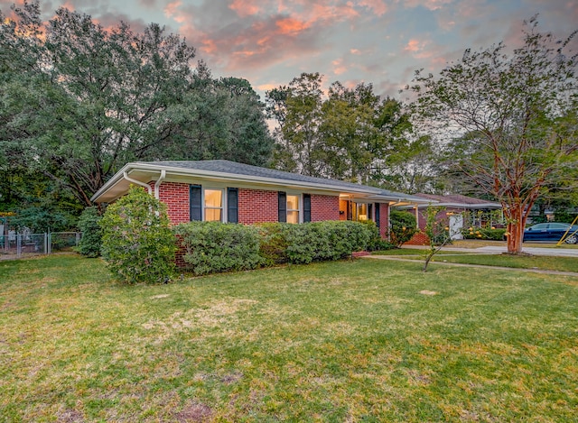 ranch-style house featuring a lawn