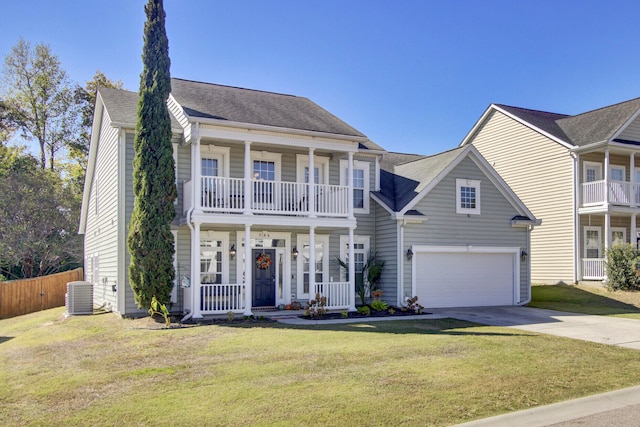 view of front facade featuring a balcony, a front yard, central air condition unit, and a porch