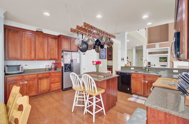 kitchen featuring black dishwasher, stainless steel refrigerator with ice dispenser, kitchen peninsula, sink, and light hardwood / wood-style floors