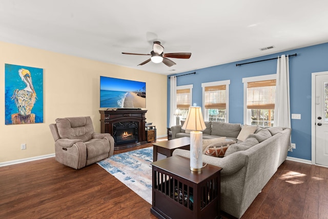 living room featuring ceiling fan and dark wood-type flooring