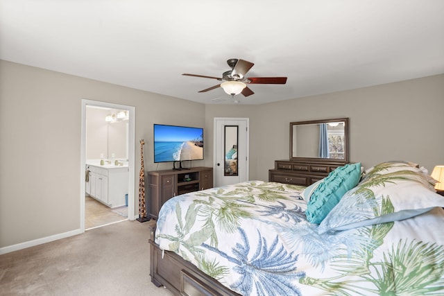 bedroom featuring ceiling fan, light carpet, and connected bathroom