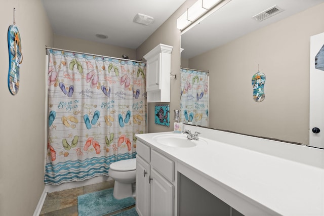 bathroom featuring walk in shower, vanity, and toilet