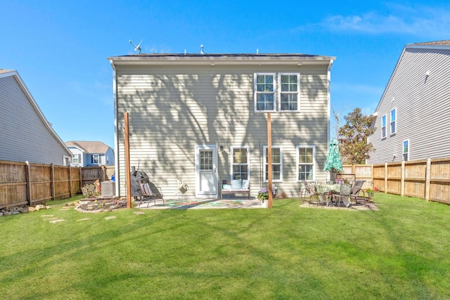 back of house featuring central air condition unit, a yard, and a patio