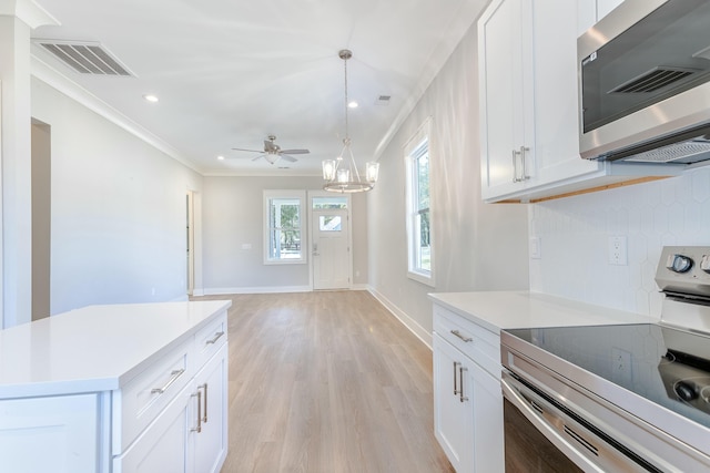 kitchen featuring visible vents, light countertops, ornamental molding, appliances with stainless steel finishes, and tasteful backsplash